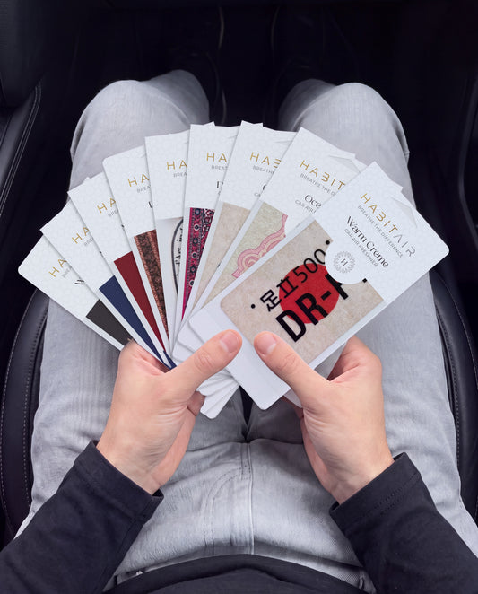 THE ENTHUSIAST PACK 🔥: hand holding the all nine HabitAir cards HabitAir retail packs in a car