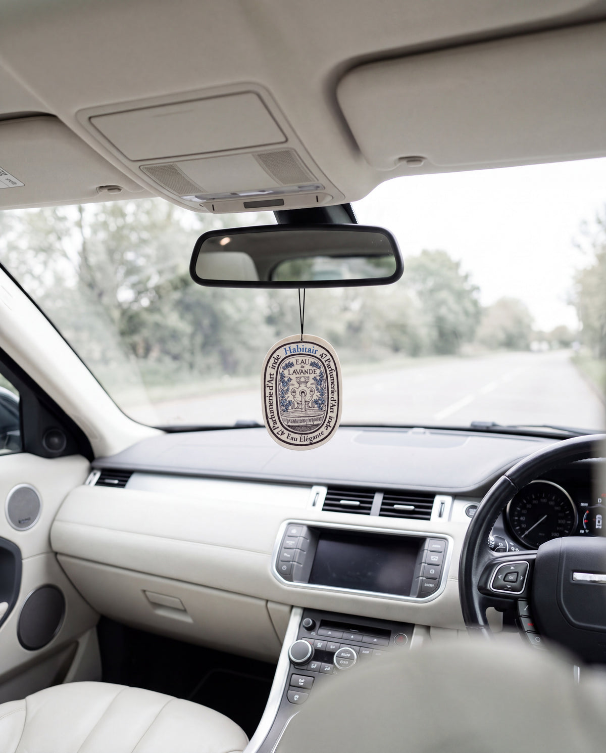 OCEANIS Premium Fragrance (Oval Edition) hanging from a car's rear-view mirror