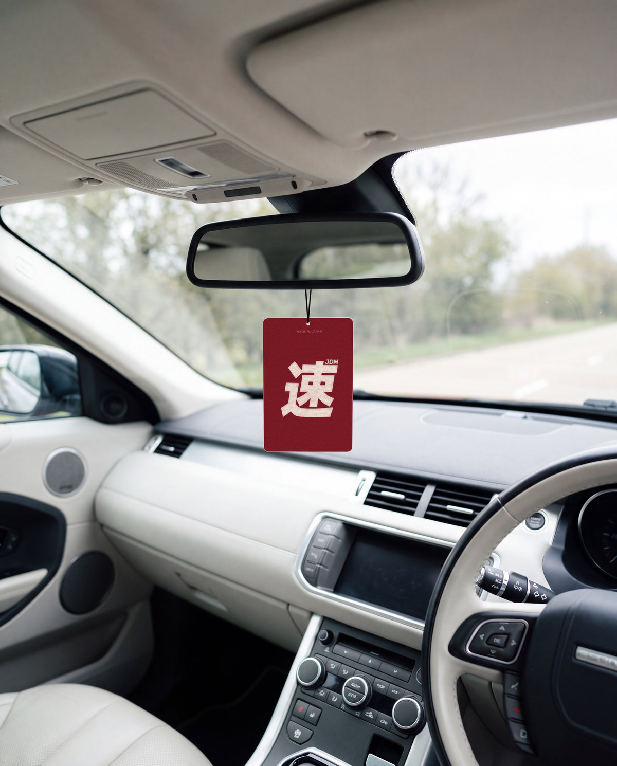 JDM Spirit hanging from a car's rear-view mirror