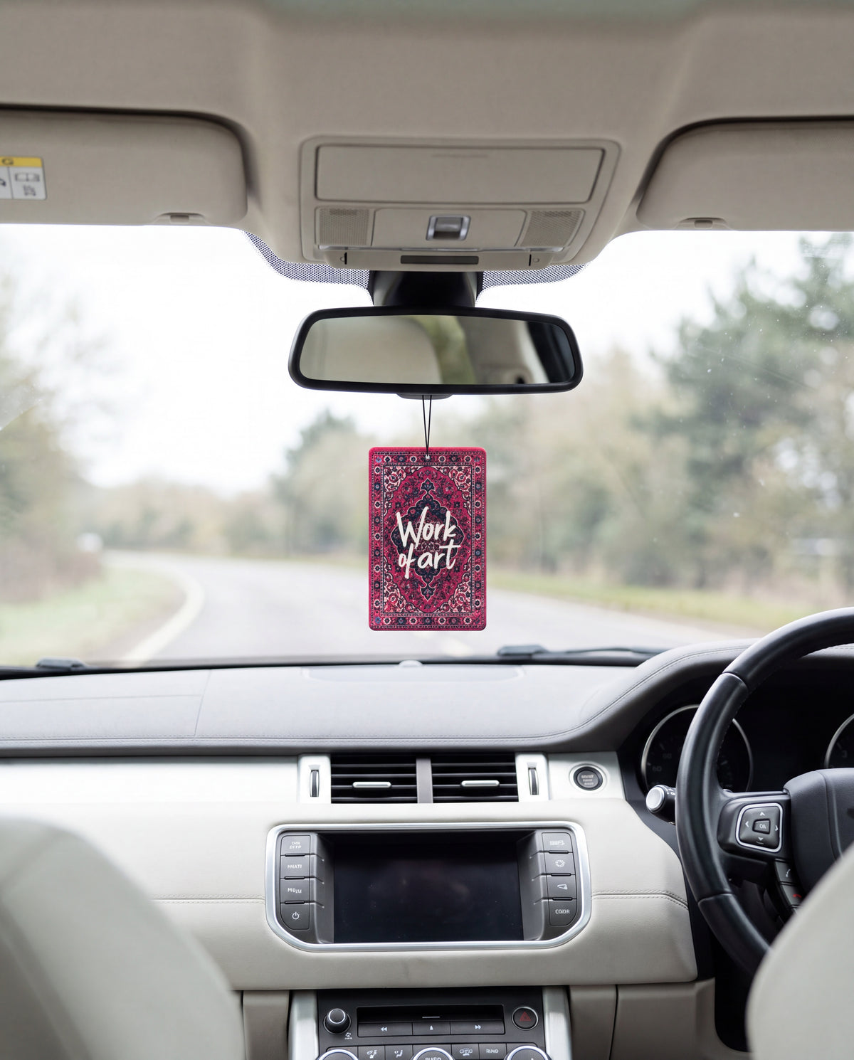 Work of Art hanging from a car's rear-view mirror