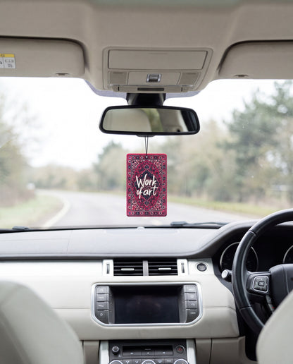 Work of Art hanging from a car's rear-view mirror