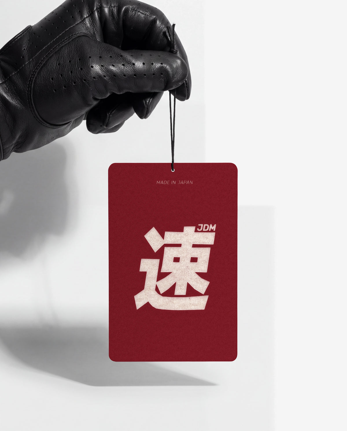 JDM Spirit card held by its string