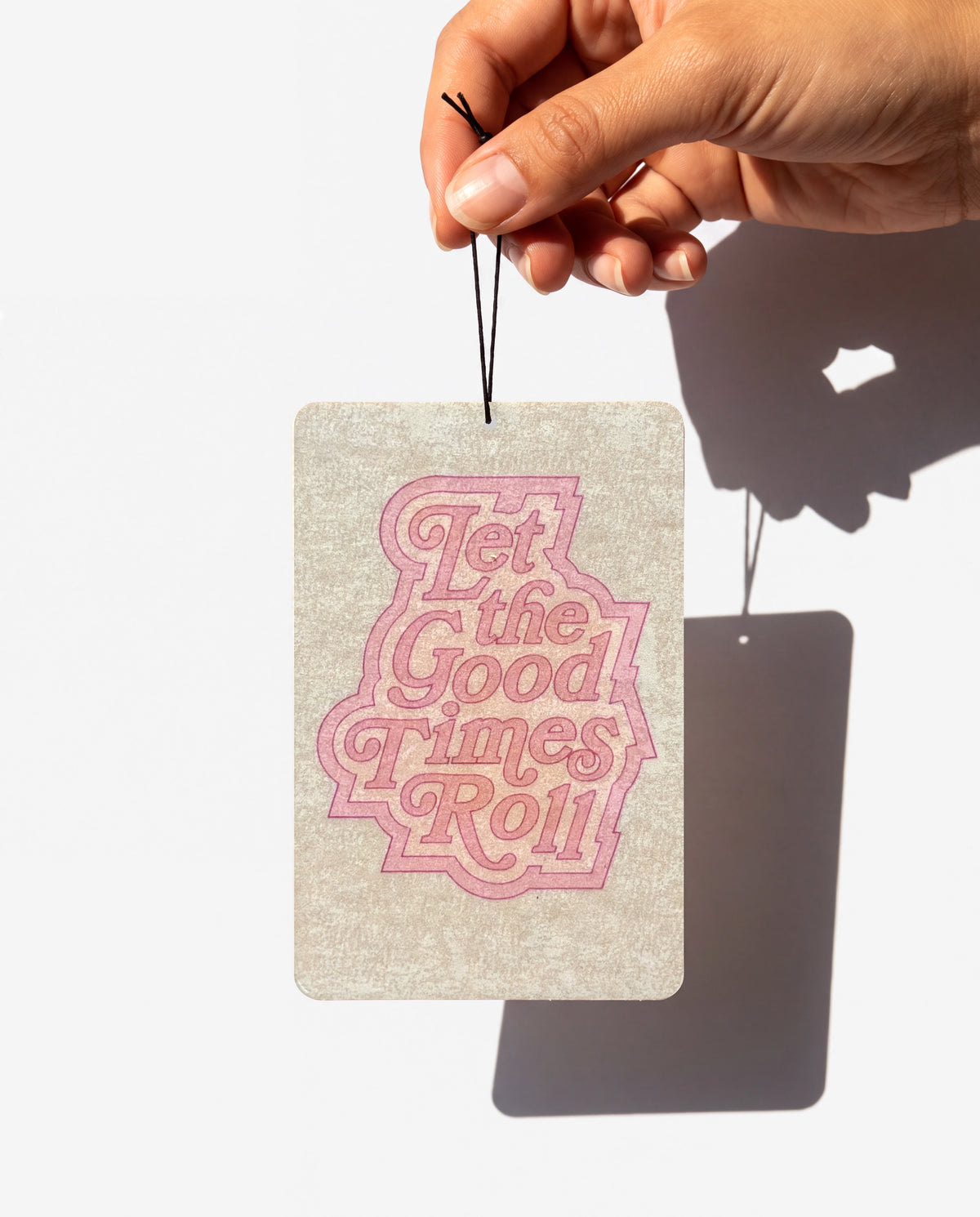 Let the Good Times Roll card held by its string
