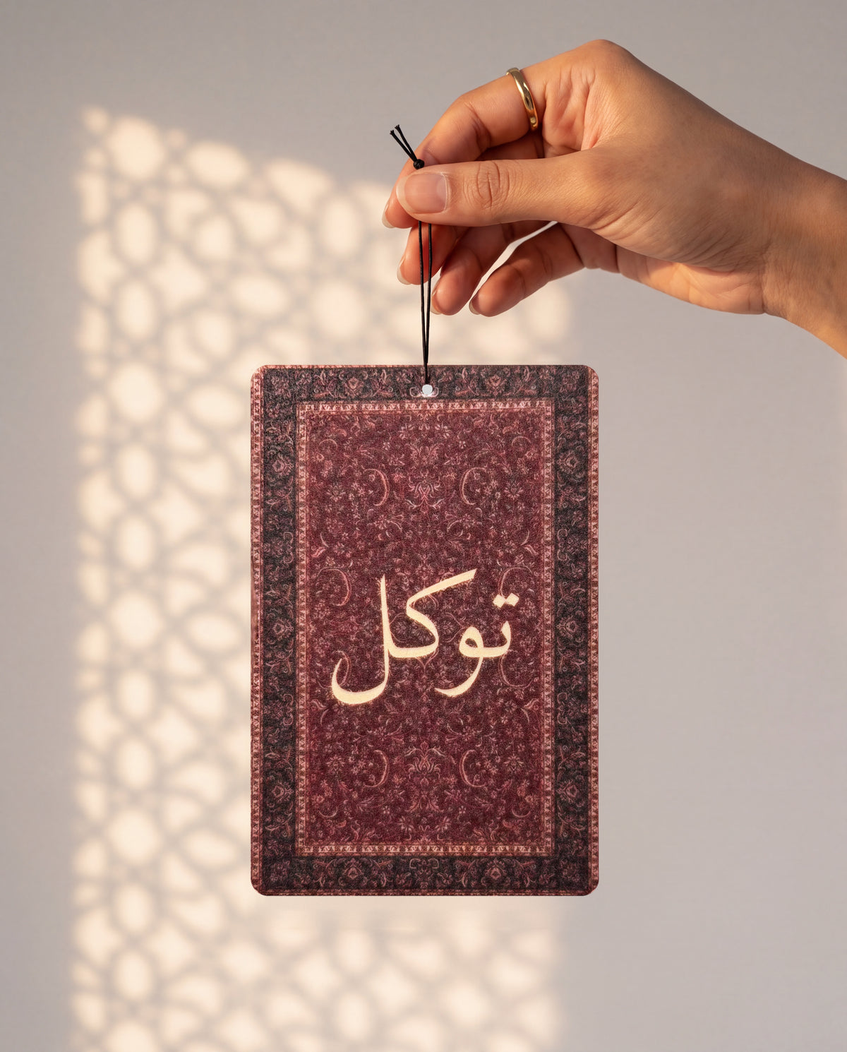 DESERT NOIR card held by its string