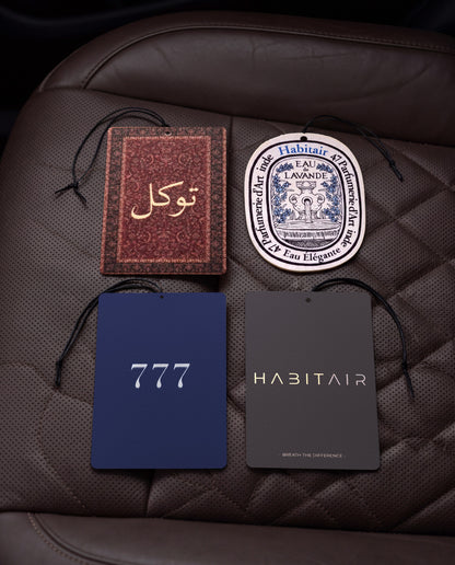 The Grand Tour Bundle: Buy 3 Get 1 Free: Tawakkul, Eau de Lavande, Lucky 777 and Habitair Classic car air freshener cards on a car interior detail