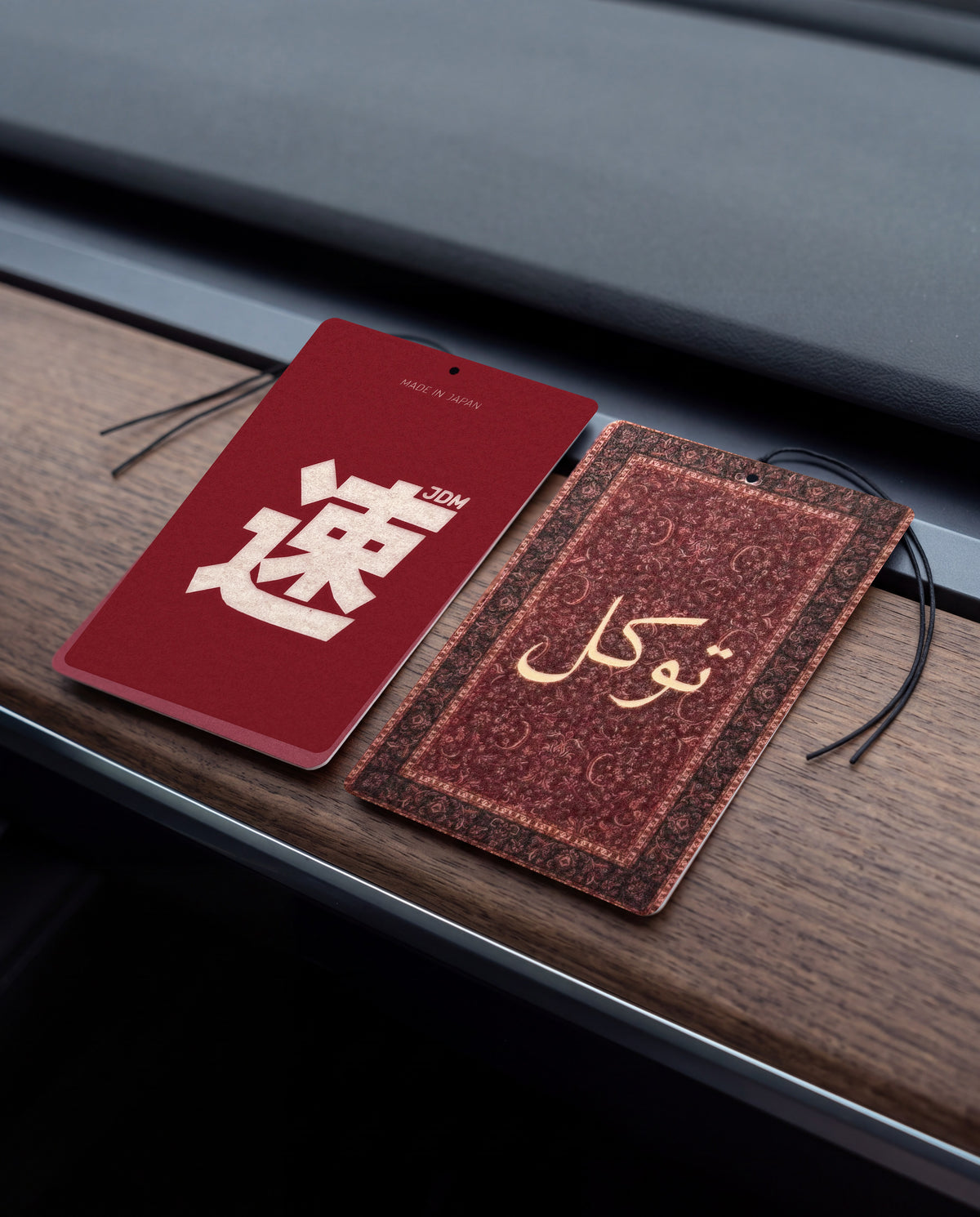 East Meets West DUO Bundle: JDM Spirit and Tawakkul car air freshener cards on a car interior detail