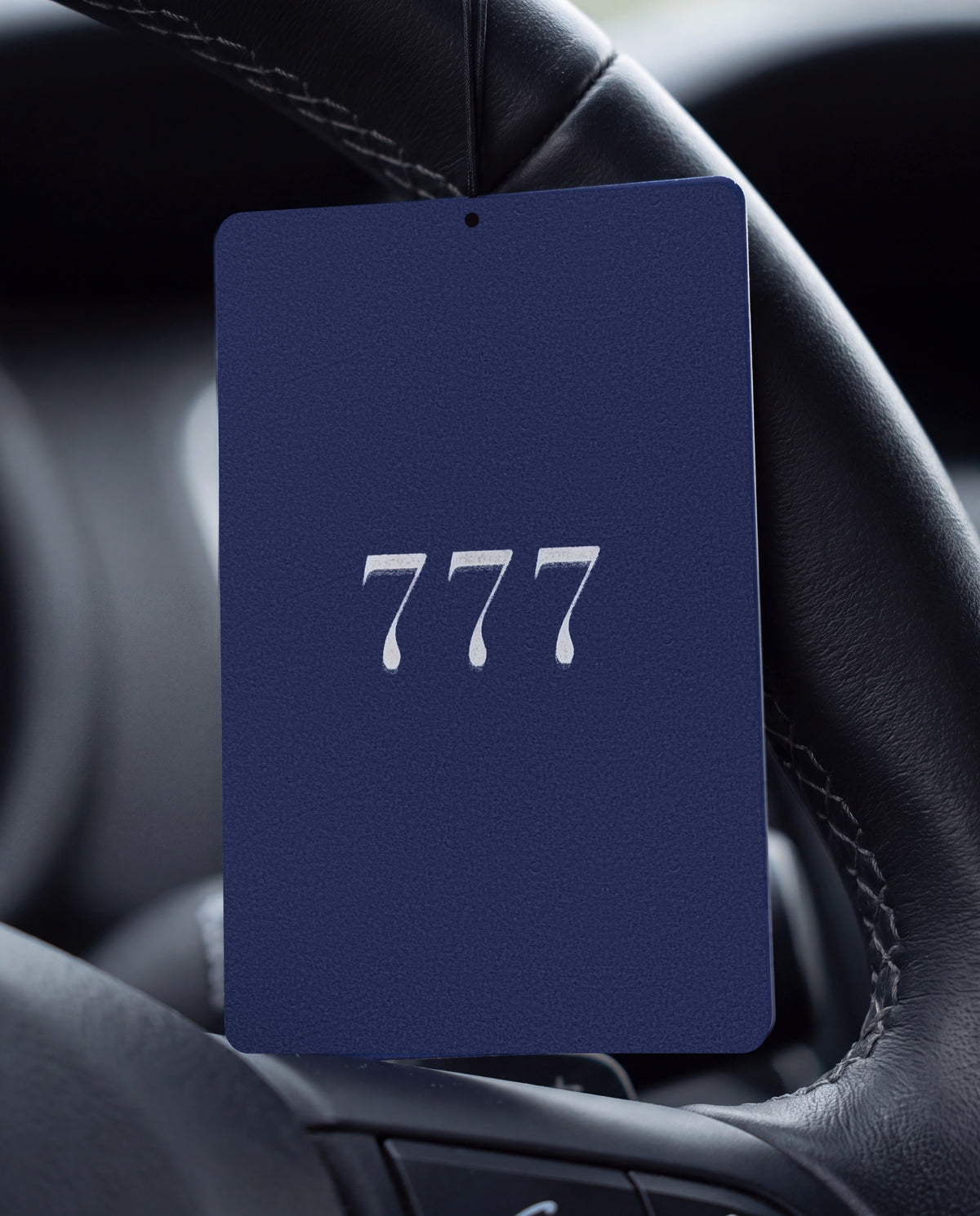 777 MOON RIDGE car air freshener card on a car interior detail