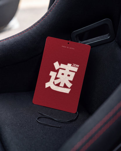 JDM Spirit car air freshener card on a car interior detail