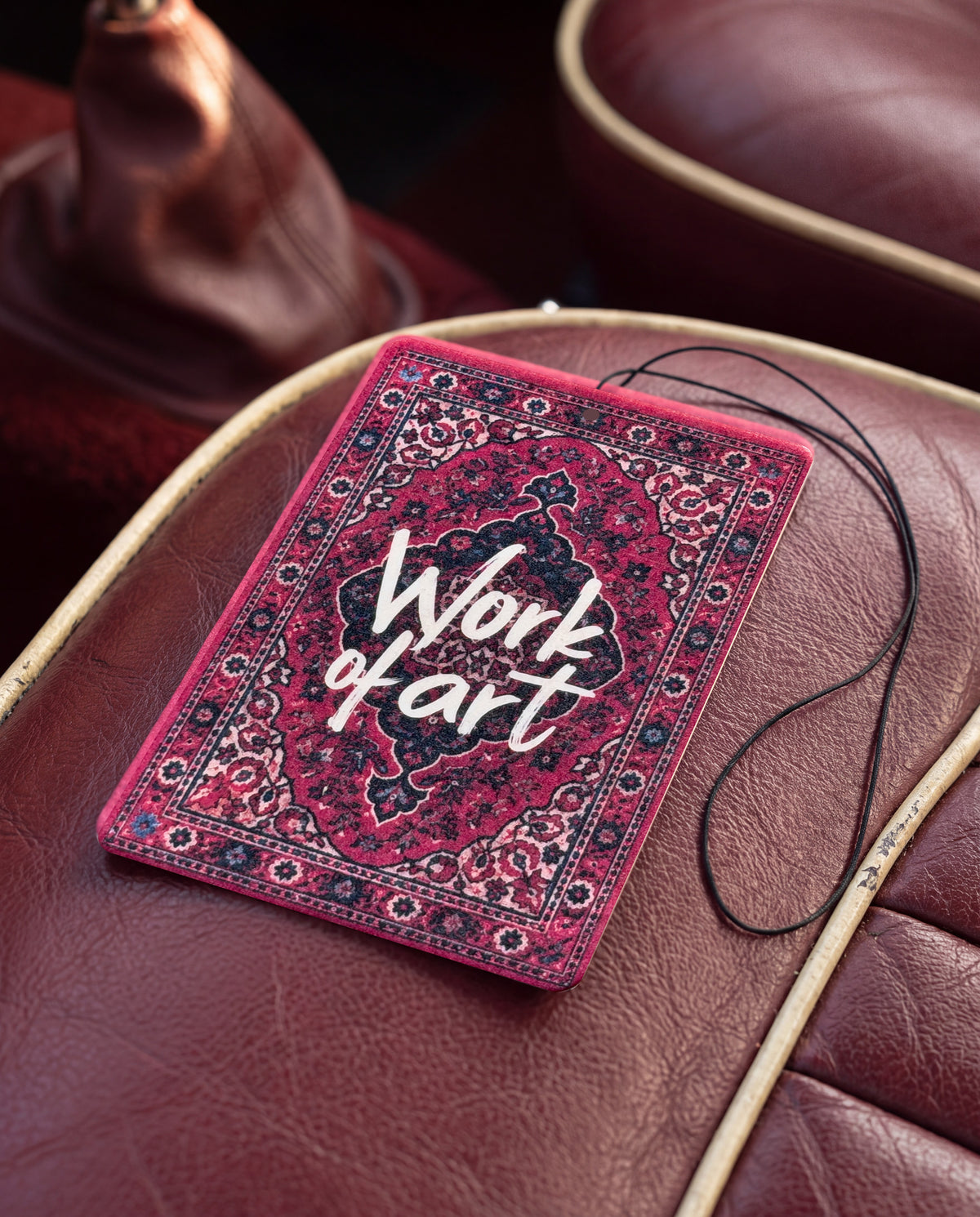 Work of Art car air freshener card on a car interior detail