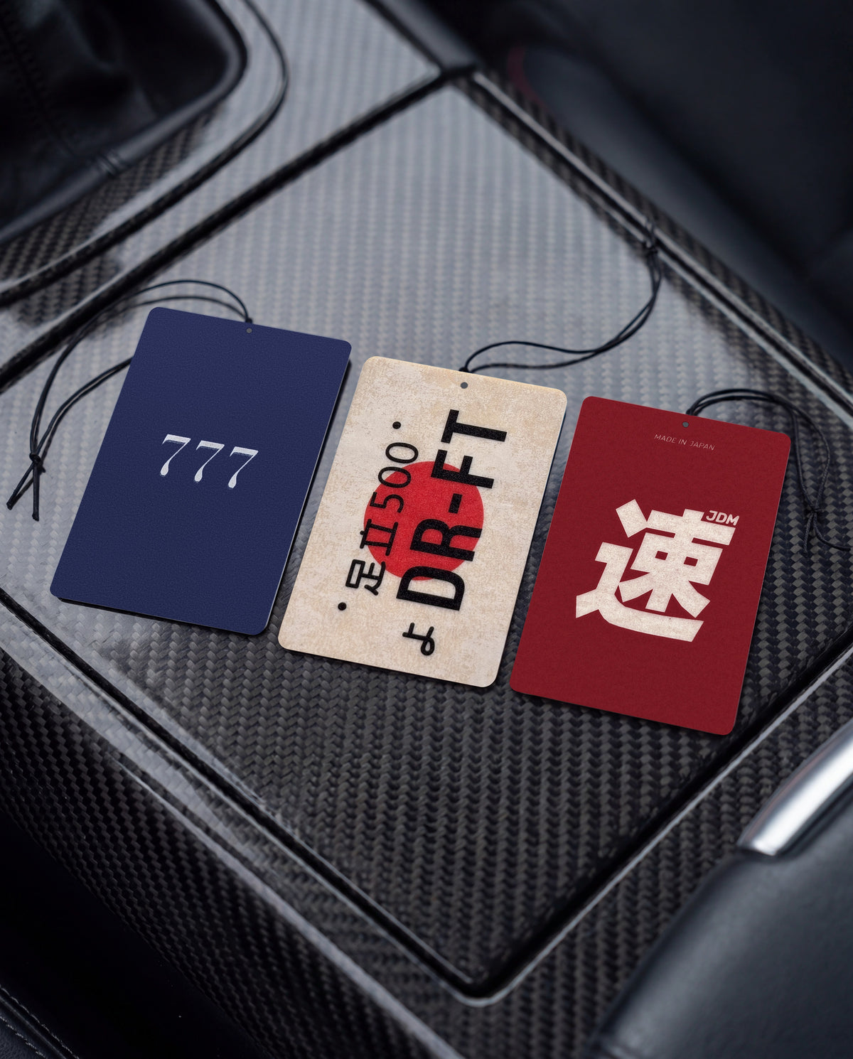 Habitair Trio: JDM LEGENDS — 3 PACK 🏁: Lucky 777, DR-FT and JDM Spirit car air freshener cards on a car interior detail