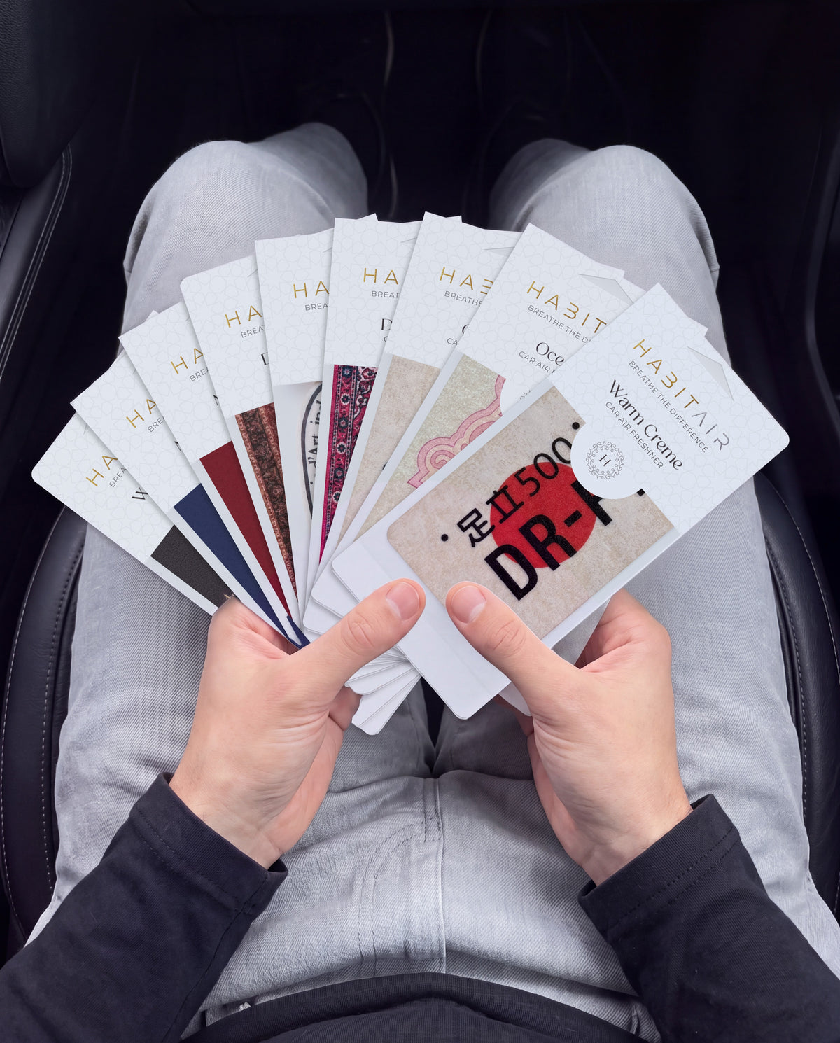 THE ENTHUSIAST PACK 🔥: hand holding the all nine HabitAir cards HabitAir retail packs in a car
