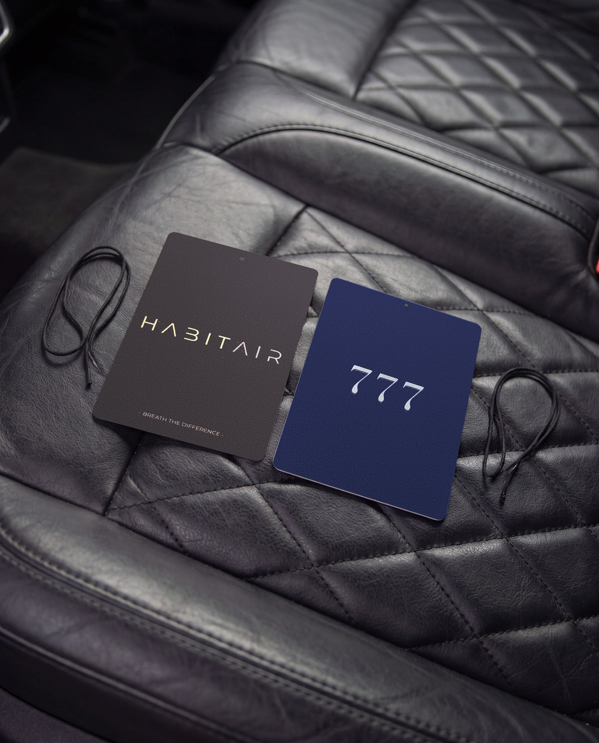 The Minimal - DUO: Habitair Classic and Lucky 777 car air freshener cards on a car interior detail